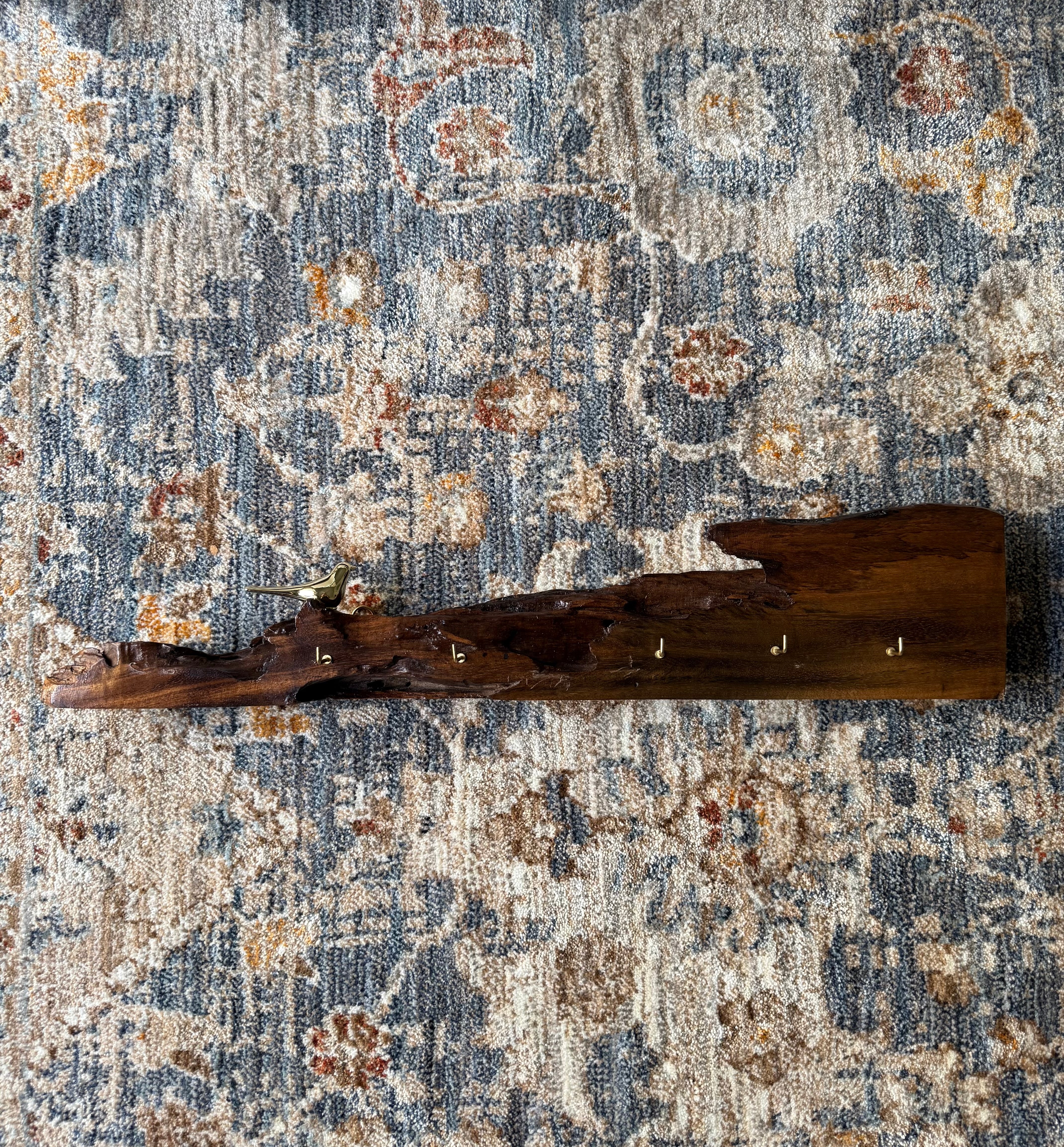Wooden decorative item on a patterned rug