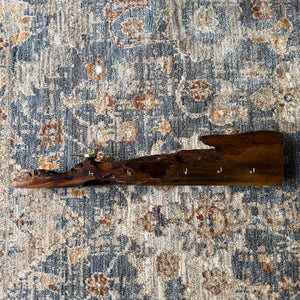 Wooden decorative item on a patterned rug